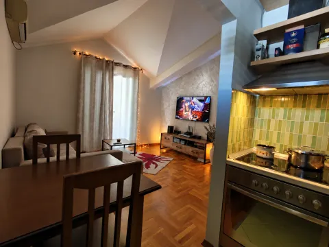 View from the kitchen towards the bright living room and dining area. - image 2