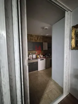 View from the hallway into the kitchen with cabinets and appliances. - image 13