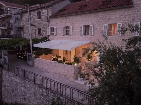 Aerial view of a traditional stone house with a furnished terrace and courtyard. - image 6