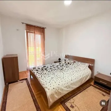 Furnished bedroom with a double bed, wardrobe, and balcony doors. - image 4