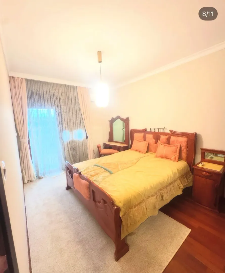 Spacious bedroom with a double bed and access to the terrace.
