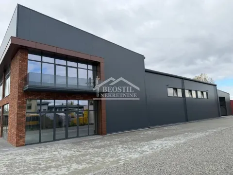 Exterior view of a commercial building with large glass surfaces and a paved courtyard. - image 5