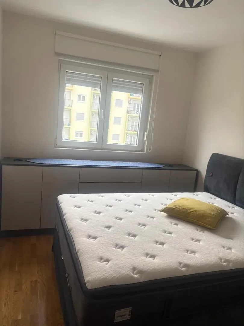 Bedroom with a double bed and a window.
