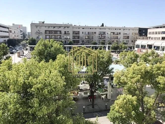 View from the window overlooking surrounding buildings and green areas.