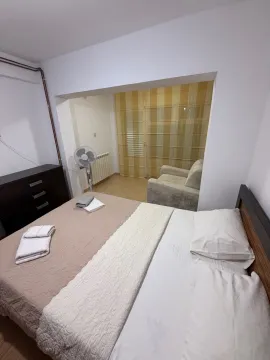 Bedroom with a double bed and an open passage to a smaller sitting area. - image 8