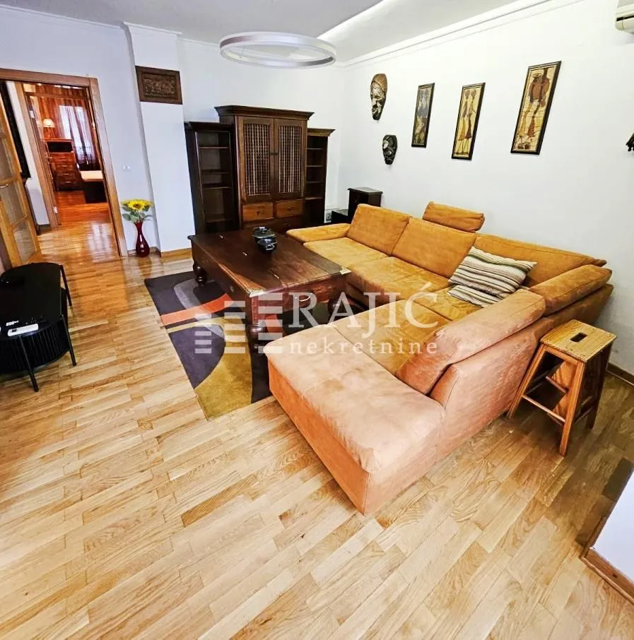 Living room with a sofa set and wooden flooring.