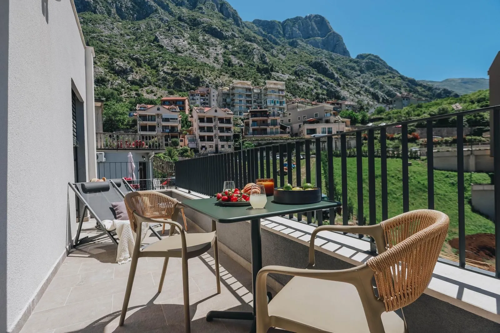 Furnished terrace with a table, chairs, and mountain views.