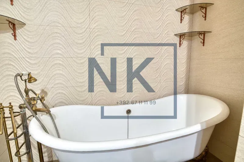 Bathroom with a freestanding bathtub and vintage faucets.