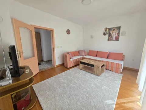 Living room with a sofa, coffee table and TV unit. - image 16