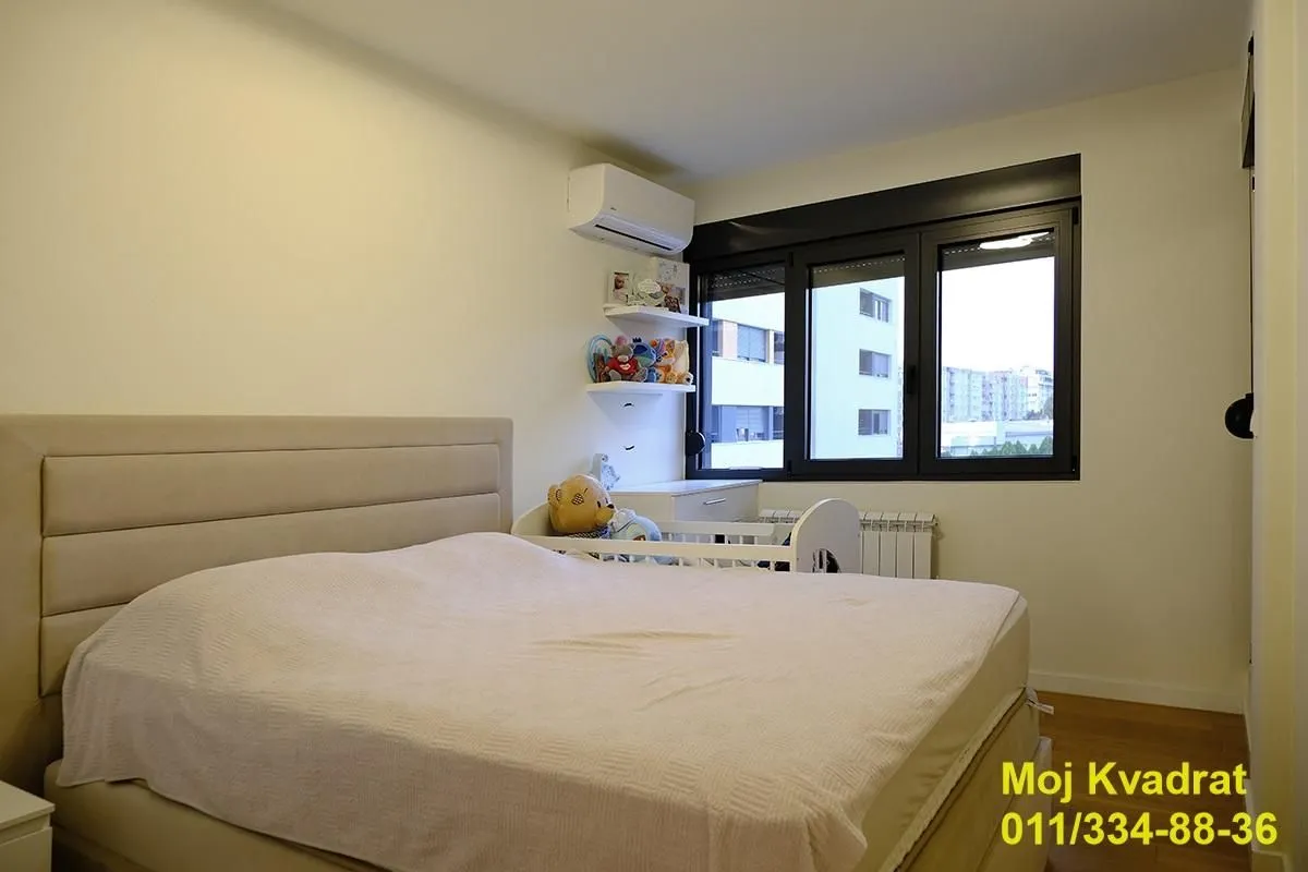 Bedroom with a double bed and a baby cot.