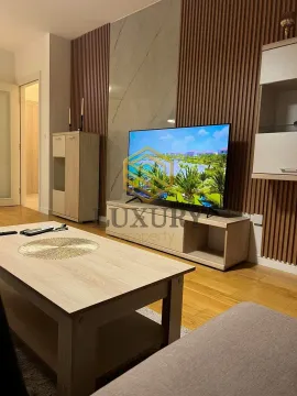 Living room with furniture, TV unit, and wooden wall panels. - image 8
