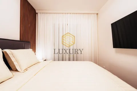 Modern bedroom with a double bed and a wall-mounted TV. - image 8