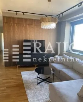 Modern living room with a sofa, wooden wall paneling, and a striking chandelier. - image 4