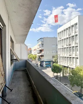 Dugi balkon sa pogledom na ulicu i okolne zgrade. - image 2