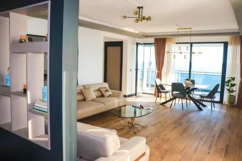 Spacious living room with a sofa set and dining area, with access to a terrace overlooking the sea. - image 3