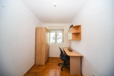 Small room with a desk, wardrobe, and wooden parquet flooring. - image 7