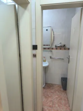 View from the hallway into a small bathroom with a sink and mirror. - image 5