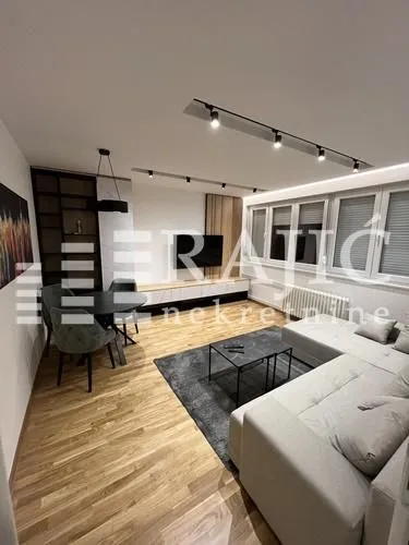 Modern and bright living room with a sofa and dining area.