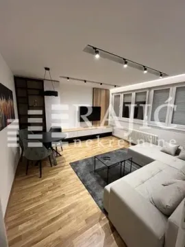Modern and bright living room with a sofa and dining area. - image 3