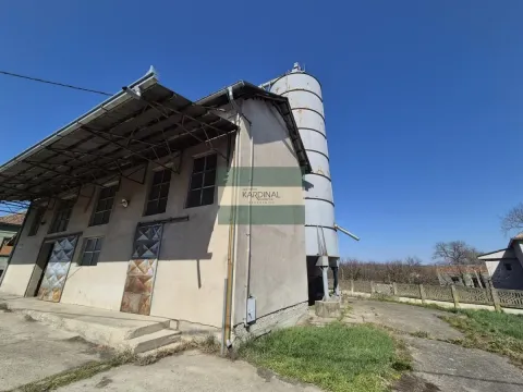 Exterior view of an industrial building with a silo and a canopy. - image 6
