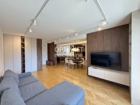 Living room with sofa, television and a view of the dining area in the background. - image 5