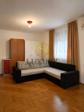 Living room with a sectional sofa, closets, and parquet flooring. - image 2