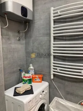 Bathroom with a washing machine, water heater, and towel radiator. - image 4