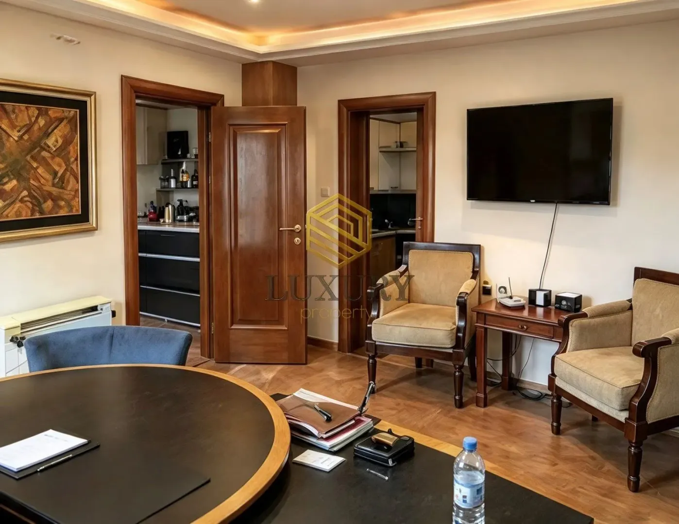 Living room with seating furniture, dining table, and a view of the interior doors.
