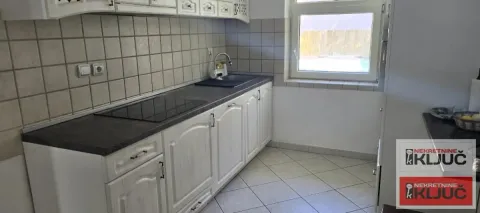Smaller kitchen with white cabinetry and a window. - image 22