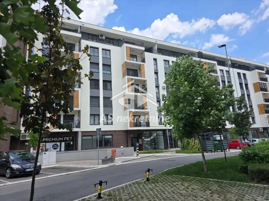 Exterior view of the residential building with a landscaped driveway and parking.