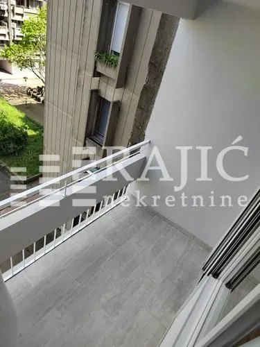 View from the tiled balcony overlooking the adjacent building.