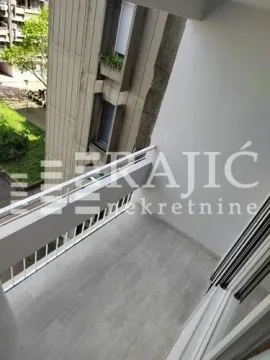 View from the tiled balcony overlooking the adjacent building. - image 13