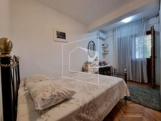 Furnished bedroom with a double bed and balcony access.