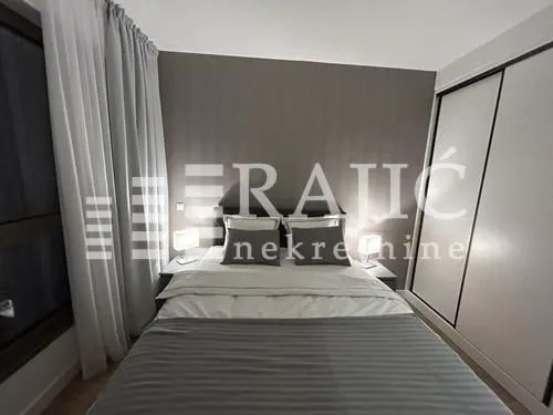 Modern bedroom with a double bed and built-in wardrobe.
