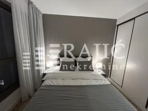 Modern bedroom with a double bed and built-in wardrobe. - image 13