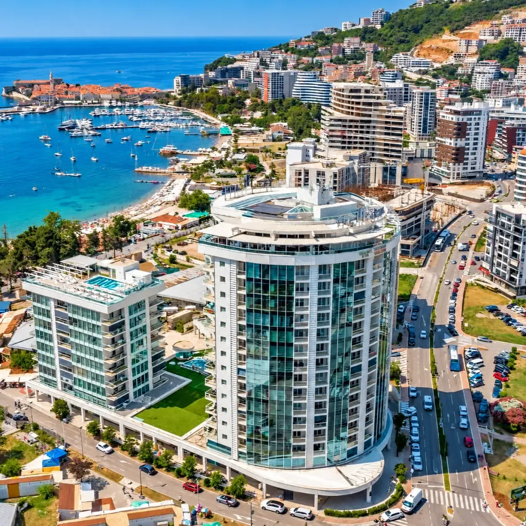 Aerial view of modern buildings and the coast with a marina.