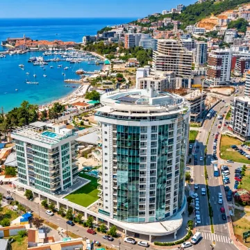Aerial view of modern buildings and the coast with a marina. - image 2