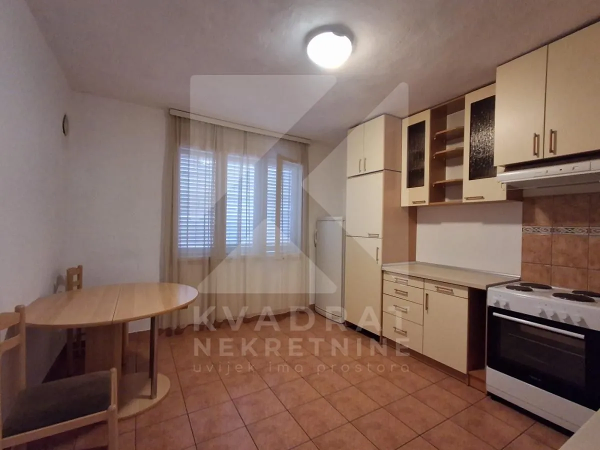 Kitchen with a dining table and window.