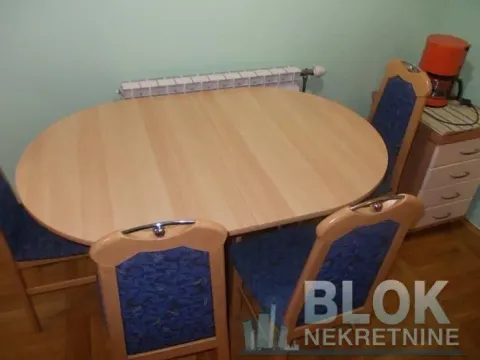 Dining table with four chairs in the living room area. - image 4