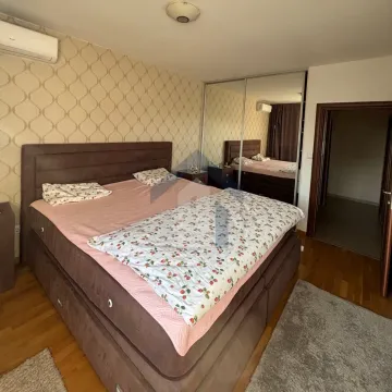 Furnished bedroom with a double bed, wardrobe, and doorway to the hallway. - image 11