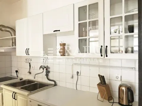 White kitchen with a sink and upper cabinets. - image 3