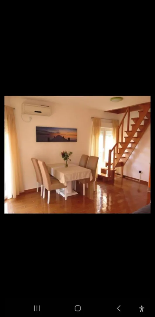 Living room with dining area and staircase.