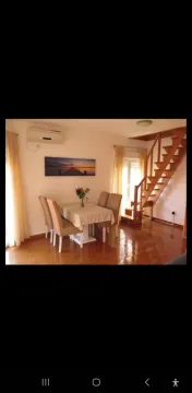 Living room with dining area and staircase. - image 2