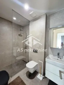 Modernly equipped bathroom with a glass walk-in shower, wall-hung toilet, and vanity sink. - image 10
