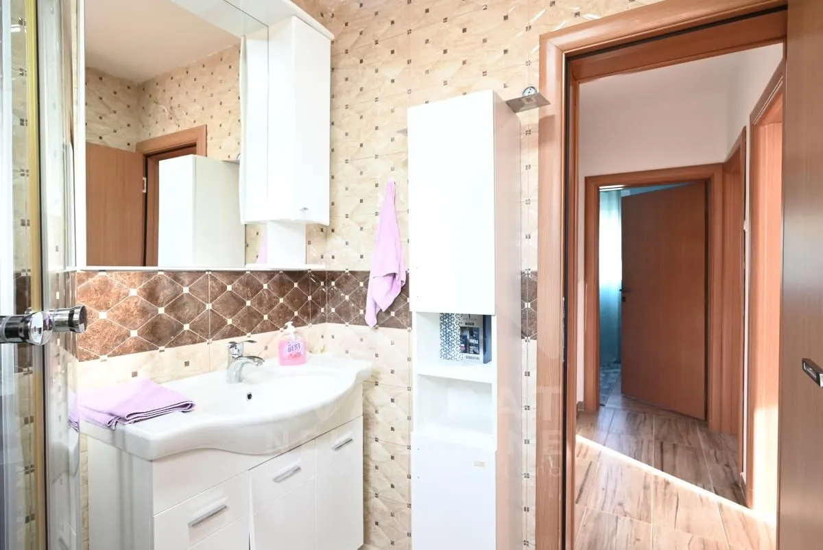 Bathroom with sink, mirror, and white bathroom cabinetry.