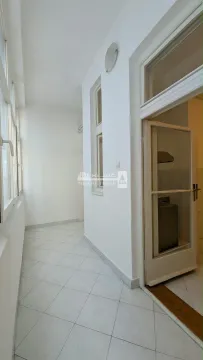 Glazed balcony with light-colored tiles and a view towards the apartment's interior. - image 6