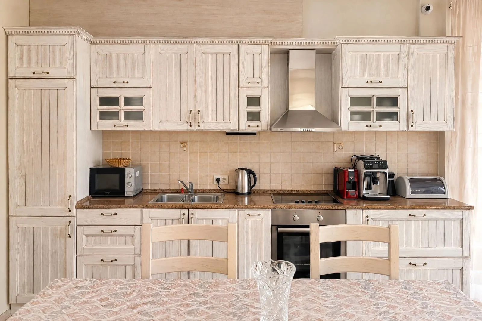 Equipped kitchen with wooden cabinets and built-in appliances.