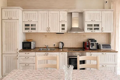 Equipped kitchen with wooden cabinets and built-in appliances. - image 6