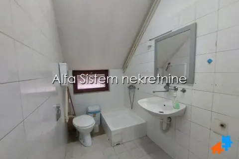 Smaller bathroom with a washbasin, toilet, and shower tray. - image 11