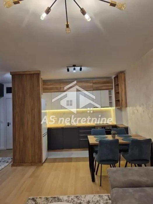 Modern kitchen with a dining area and built-in wooden cabinetry.